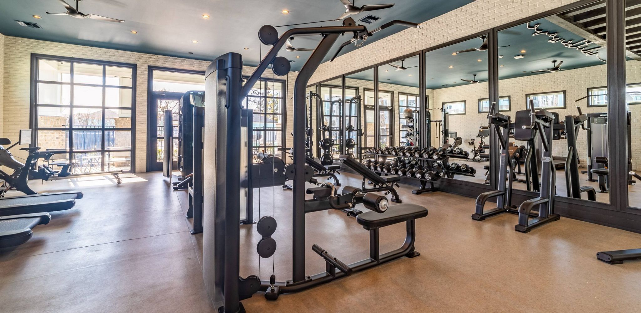 Hawthorne at The Mill resident fitness center with free weights and machines